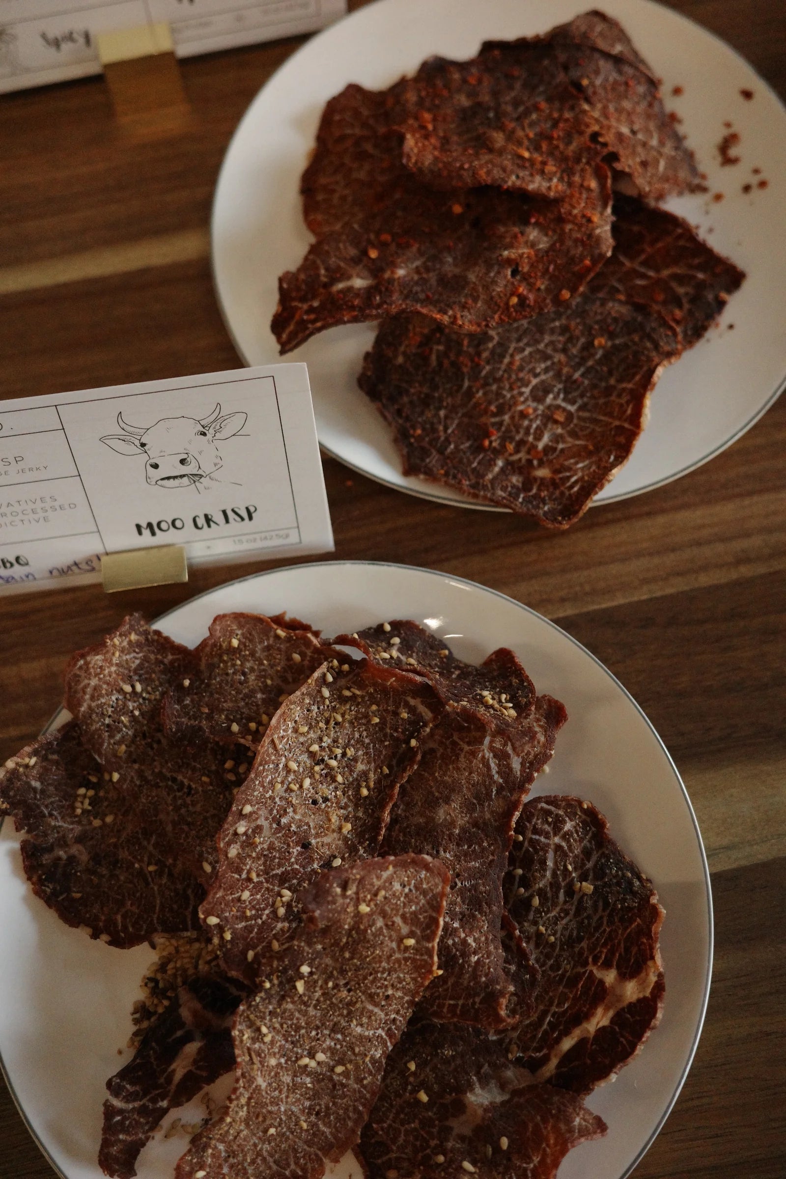 Finished crisps plated beside the Moo Crisp card