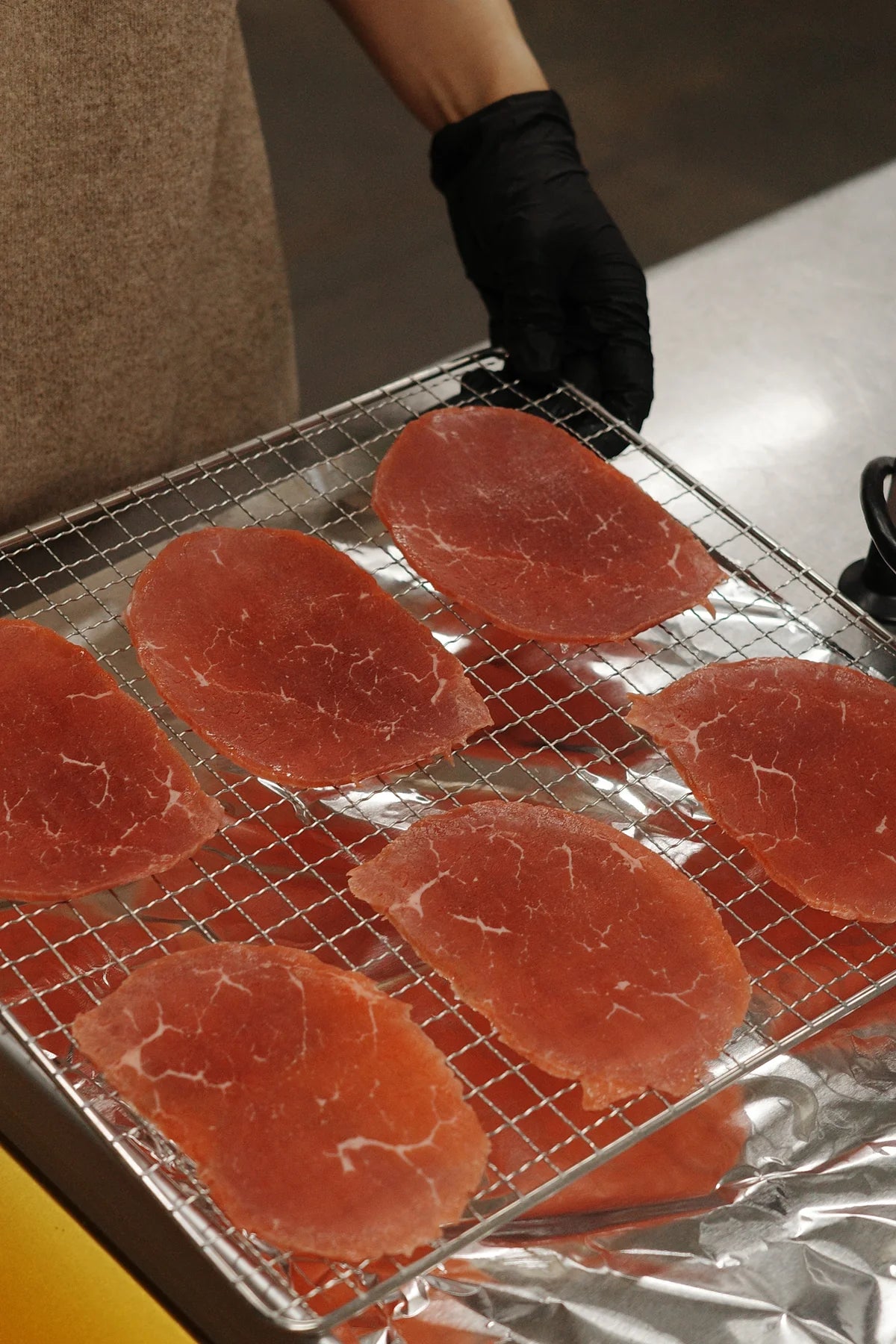 Marinated slices laid across the drying rack